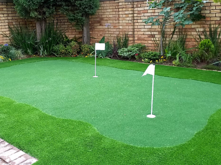 putting artificial grass areas in back garden
